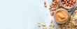 © Pixel-Shot - Jars with tasty peanut butter and nuts on color background with space for text