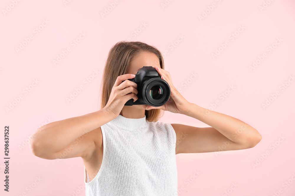Female photographer on color background