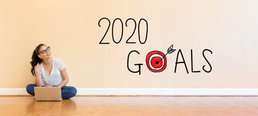 Poster - 2020 Goals text with young woman using a laptop computer on floor