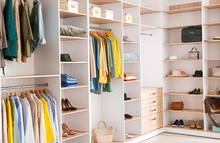 Big Wardrobe With Clothes In Dressing Room