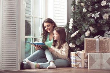 Mother and daughter reading book