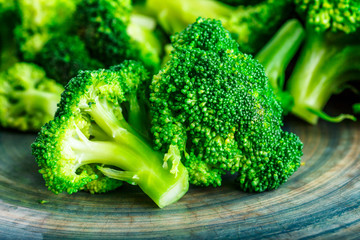 Macro photo green fresh vegetable broccoli. Fresh green broccoli on a black stone table.Broccoli vegetable is full of vitamin.Vegetables for diet and healthy eating.Organic food.