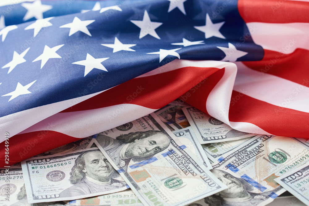 USA national flag and the dollar bills. Business and finance concept - obrazy, fototapety, plakaty 