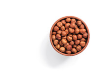 Hazelnuts In A Bowl On A White Background, Isolated. View From Above. Hazelnuts Without Shell