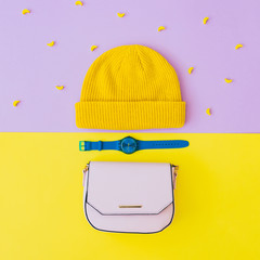 Wall Mural - Fashionable flat lay set with yellow beanie hat, blue watches and pink bag