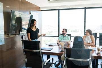 Wall Mural - Businesswoman Positively Explaining New Project In Meet At Office