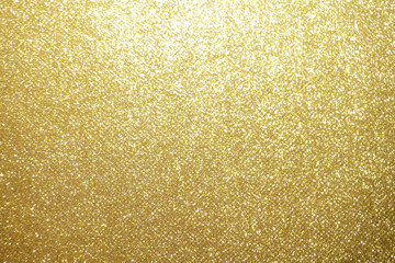 gold Sparkling Lights Festive background with texture. Abstract Christmas twinkled bright bokeh defocused and Falling stars. Winter Card or invitation	