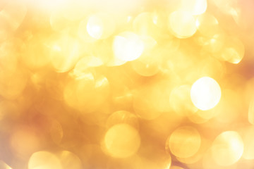 Wall Mural - golden color blurred abstract background. yellow bokeh christmas blurred beautiful shiny Christmas lights.