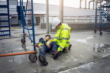 First aid support accident in site work, Builder accident fall scaffolding to the floor, Safety team help employee accident.