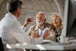 © Drazen - Mature couple talking to a doctor about supplement plans during a meeting.