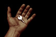 © PT pictures - shiny key in the open hand palm on a black background copy space