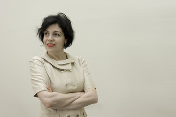 Portrait of smiling middle aged business woman with crossed arms.