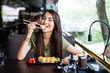 © F8  \ Suport Ukraine - Beautiful young girl enjoying sushi in a cafe on a sunny day