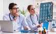 © Elnur - The two doctors examining x-ray images of patient for diagnosis