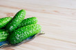 Cucumber gherkins on a light wooden background. View from above. Place for text.
