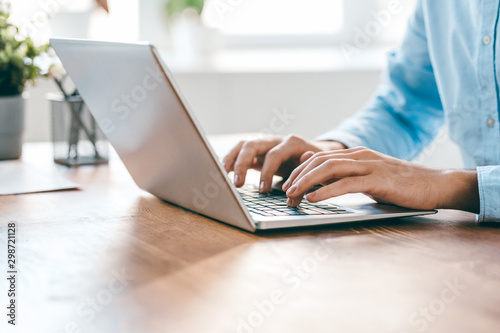 Fotografía Hands of young contemporary office manager over laptop keypad during work