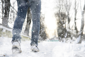 A man walks through the city on snowy winter day.