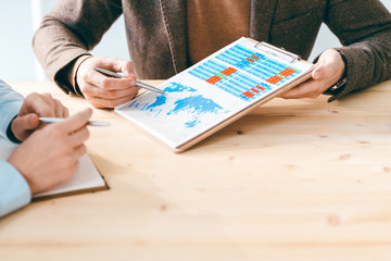 Aufkleber - Contemporary businessman showing colleague document with financial chart