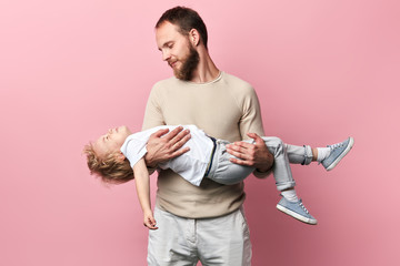 Wall Mural - pleasant handsome man spending time with his son. close up photo.