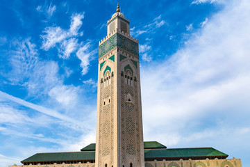 View of Hassan II mosque against blue sky - The Hassan II Mosque or Grande Mosquée Hassan II is a mosque in Casablanca, Morocco.