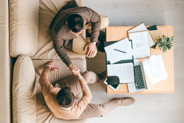 Aufkleber - Overview of two young business partners shaking hands after negotiating