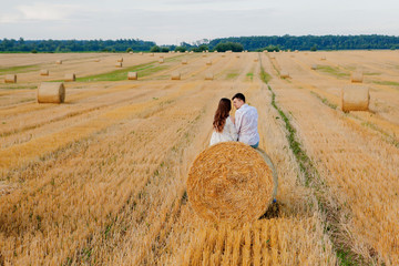 Happy young couple on straw, romantic people concept, beautiful landscape, summer season