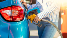 Pumping Gas At Gas Pump. Woman Refuel The Car. Woman  At The Petrol Station. Woman Filling Her Car With Petrol At Gas Station. Pumping Fuel In To The Tank. Detail Of Woman Filling Car With Diesel