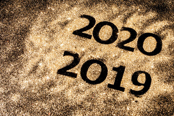 Beautiful sparkling Golden Numbers of 2019 to 2020 on black background for design, happy new year concept