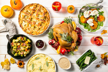 Wall Mural - Selection of traditional thanksgiving food - turkey, mashed patatoes, green beans, apple pie on rustic background, top view
