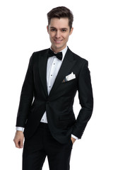 Poster - young modern man in tuxedo smiling on white background