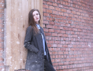 Young girl outdoors in winter. Model girl posing outdoors on a winter day. A festive weekend in the street walking girl.