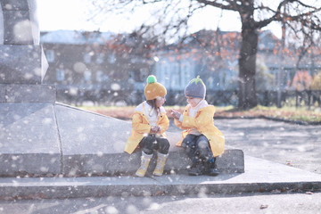 Kids walk in the park first snow