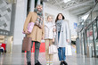 © pressmaster - Young cheerful family of three in coats carrying paperbags