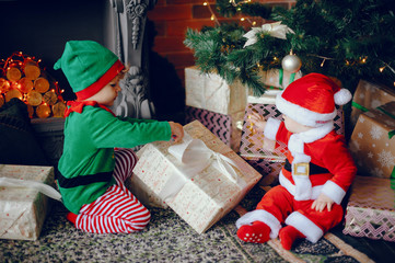 Poster - Cute little boys in a christmas costumes. Children by the christmas tree