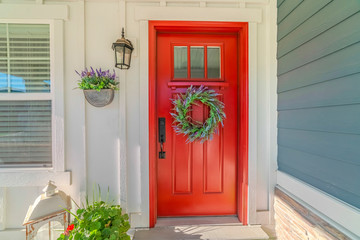 Wall Mural - Red front door of modern home with green wreath