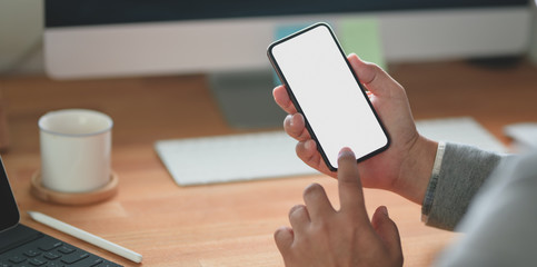 Wall Mural - Close-up view of professional businessman looking at his blank screen smartphone