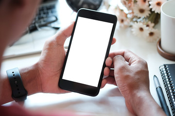 Mock up smartphone of man hands holding smart phone with blank copy space screen for your text message or information content, female reading text message on cell telephone during in urban setting.