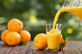 orange juice pouring in glass