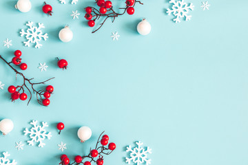 christmas or winter composition. snowflakes and red berries on blue background. christmas, winter, n