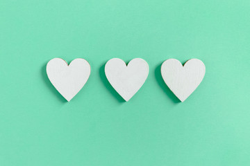 Composition with white hearts on mint background