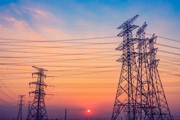 High voltage tower silhouette and sky landscape at dusk