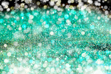 Aquamarine Sparkling Lights Festive background with texture. Abstract Christmas twinkled bright bokeh defocused and Falling stars. Winter Card or invitation