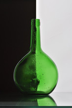 Green Glass Bottle On Black Background Studio Shot