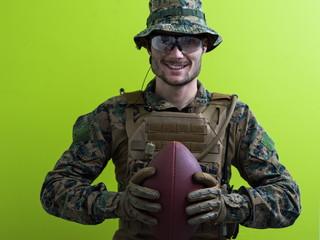 solder holding american football ball