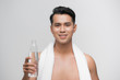 © makistock - Young asian man with bottle of the water, isolated on white background
