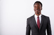 © Ranta Images - Young handsome African businessman wearing suit against white ba