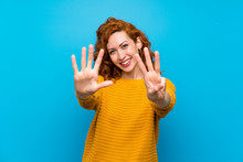Redhead Woman With Yellow Sweater Counting Eight With Fingers