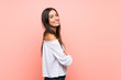 © luismolinero - Young woman over isolated pink background with arms crossed and looking forward