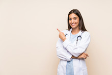 Young Doctor Woman Over Isolated Background Pointing Finger To The Side
