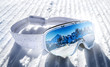 Ski goggles on white new groomed snow. Ski items or equipment concept.